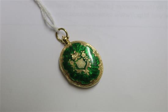 A 15ct gold and green enamel oval locket pendant, 30mm.